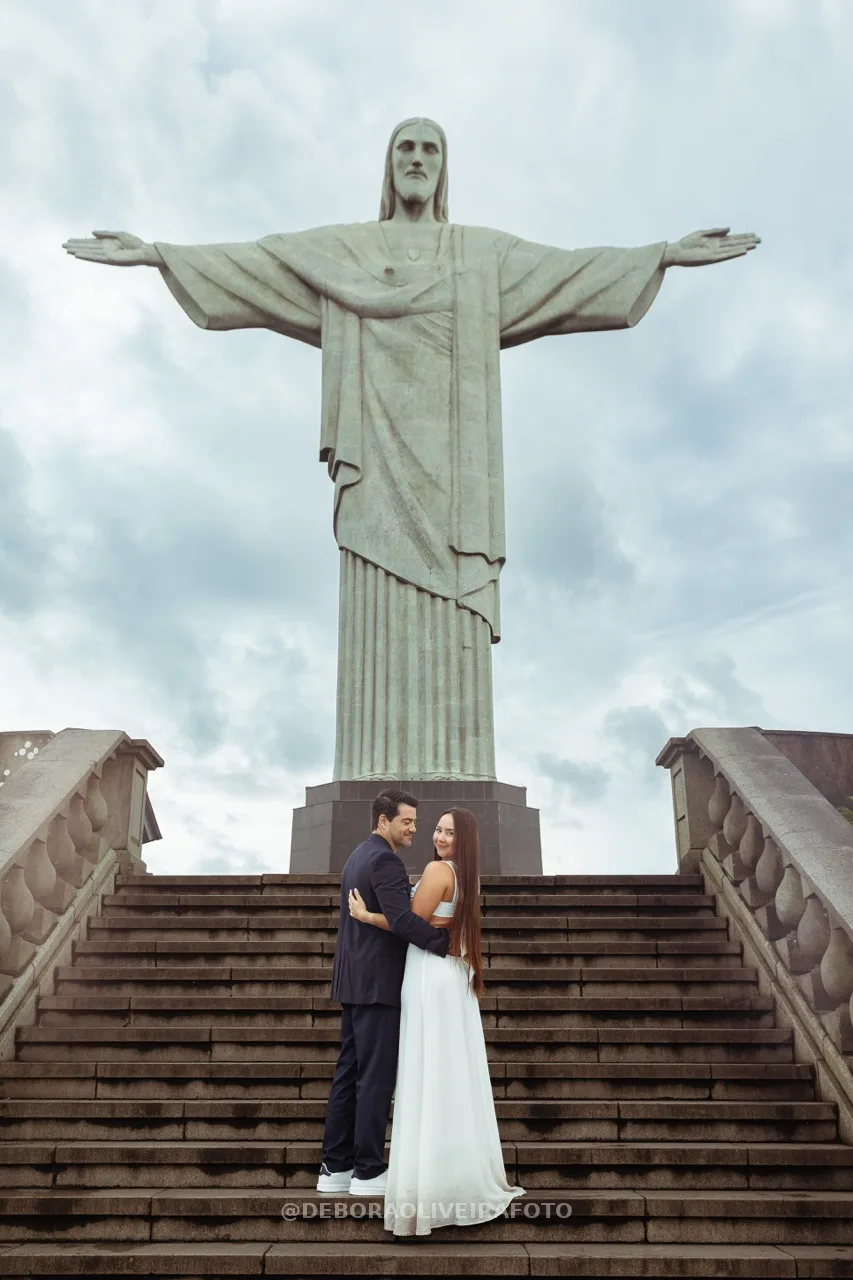 Couple looking at camera on Cristo stairs after engagement – photo 21