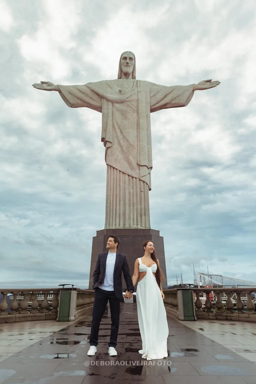 Couple holding hands in front of Cristo Redentor statue – photo 2