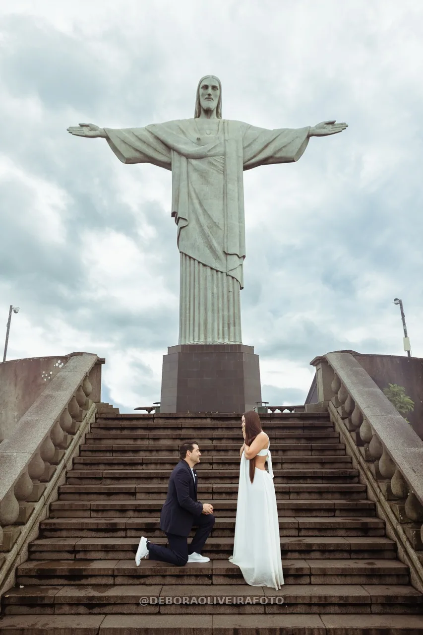 Andres on one knee proposing on the stairs of Christ the Redeemer – photo 15