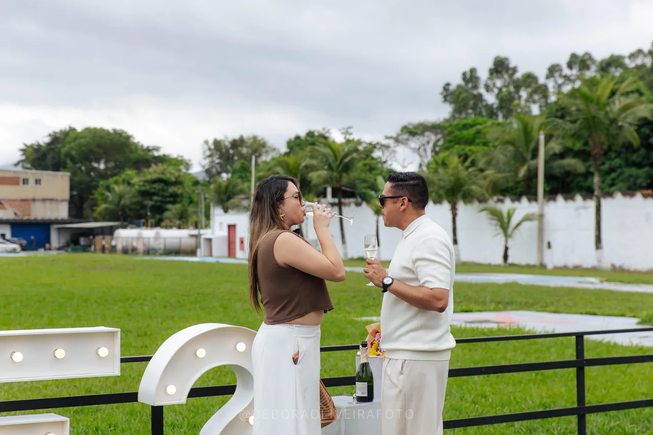Couple toasting with sparkling wine on the heliport lawn