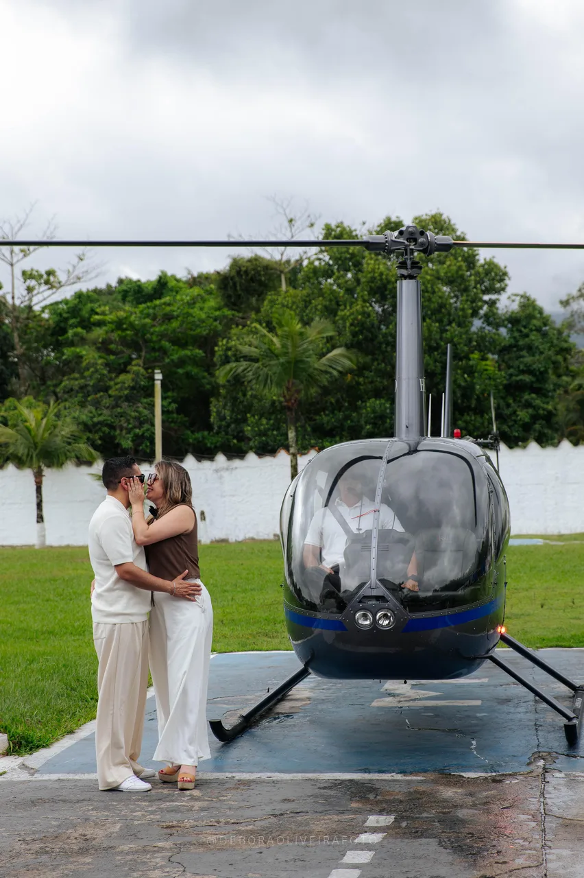 Juan and Andrea in front of the helicopter on the helipad