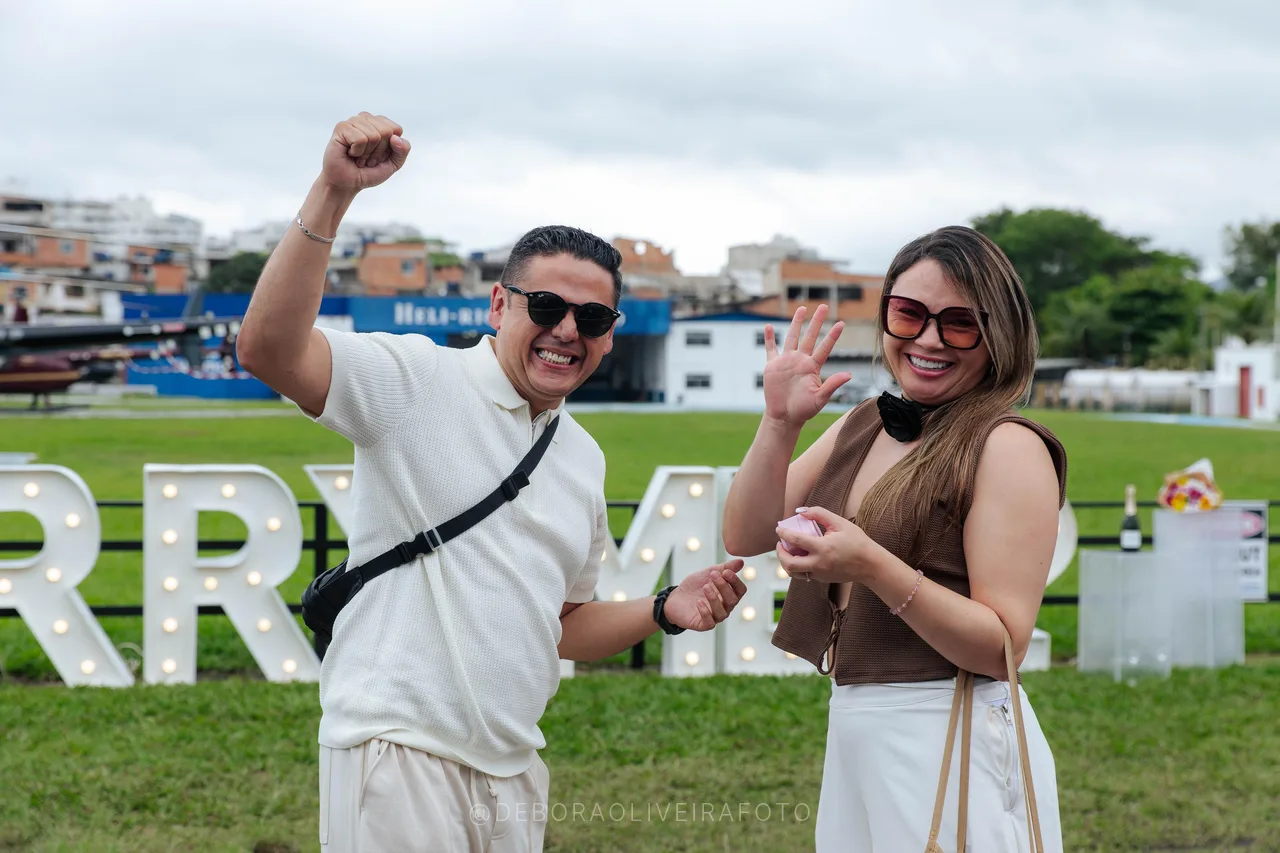 Juan celebrating and Andrea showing her engagement ring at the heliport