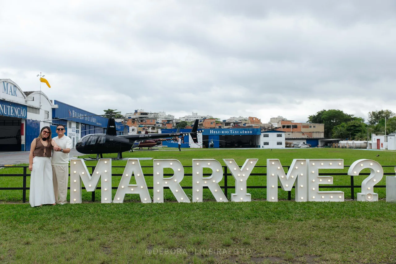 Wide view of the Marry Me sign on the heliport lawn in Rio de Janeiro