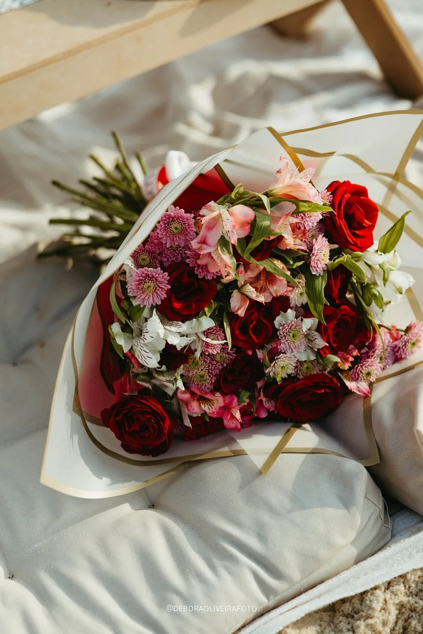 Bouquet of red and pink flowers on the picnic cushions