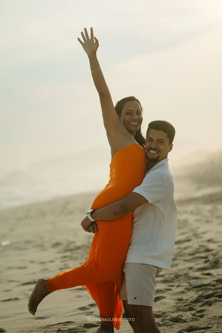 Samuel lifting Emile as she raises her arm