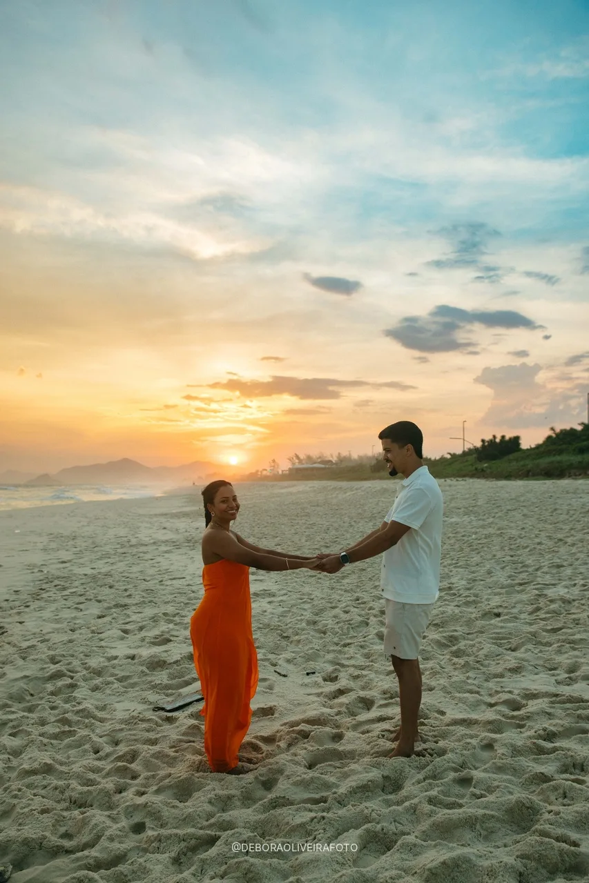 Couple holding hands on the beach at sunset in Rio de Janeiro