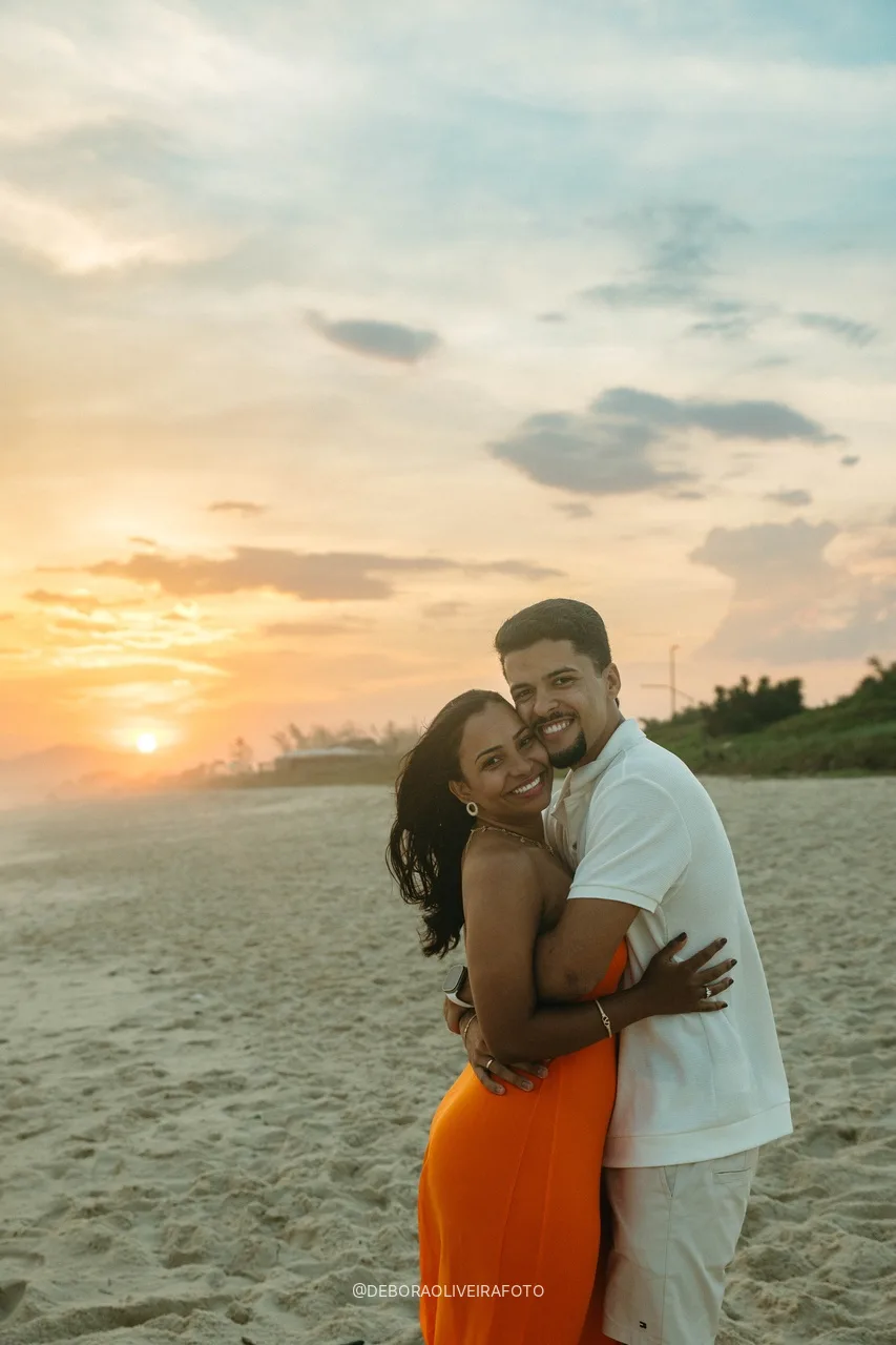 Emile and Samuel hugging with the sunset behind