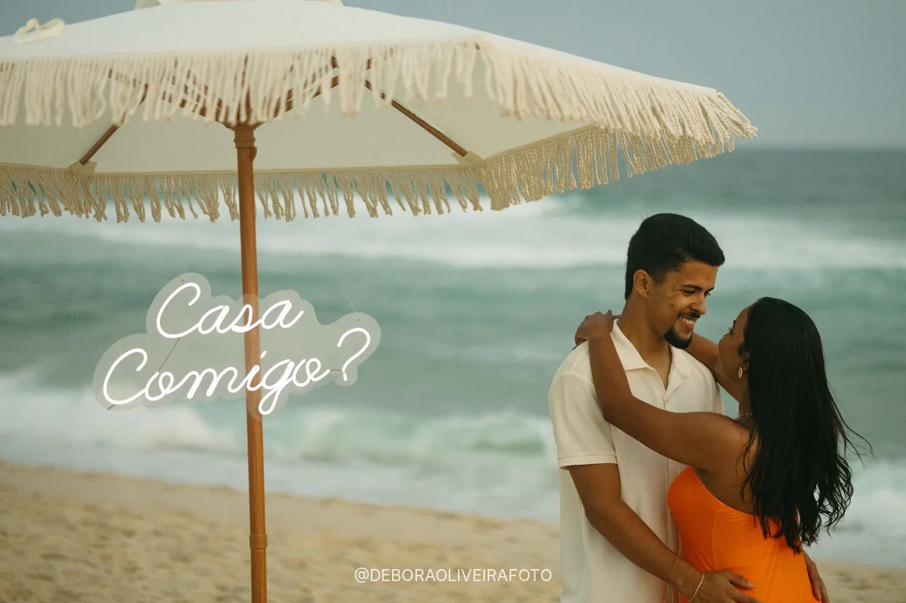 Samuel and Emile next to the Casa Comigo sign under the umbrella