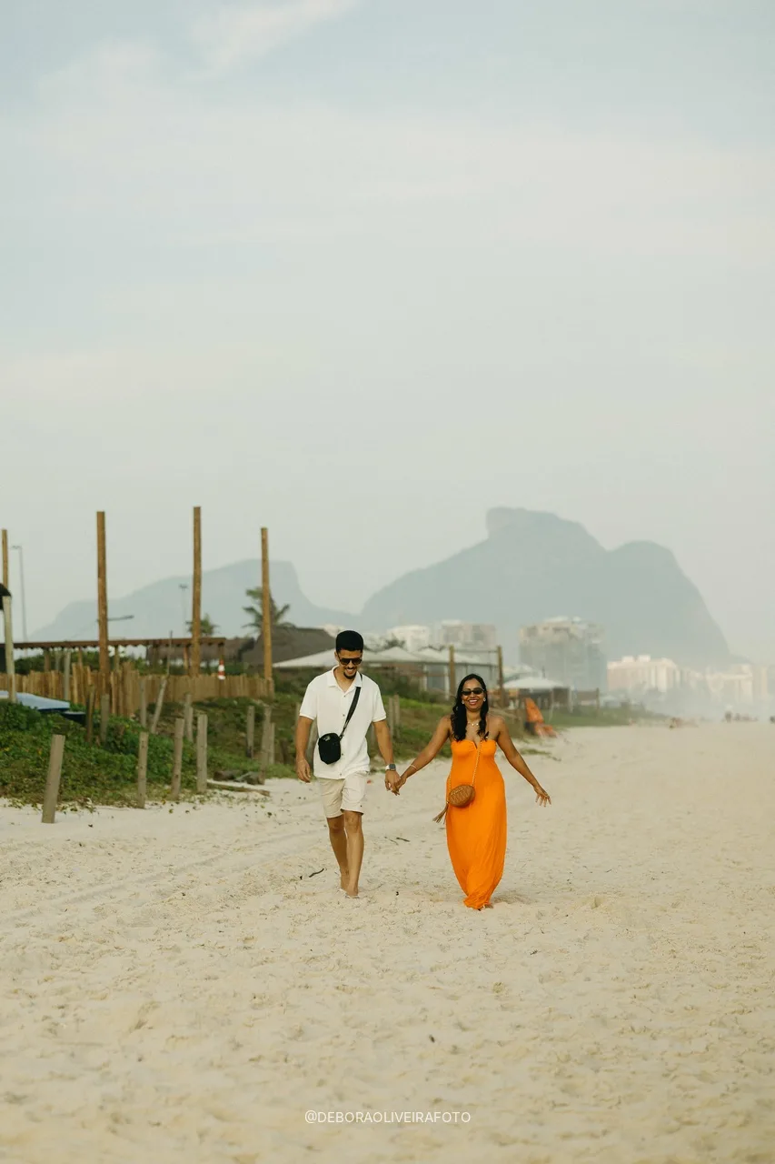 Samuel and Emile walking on the beach with Pedra da Gávea behind