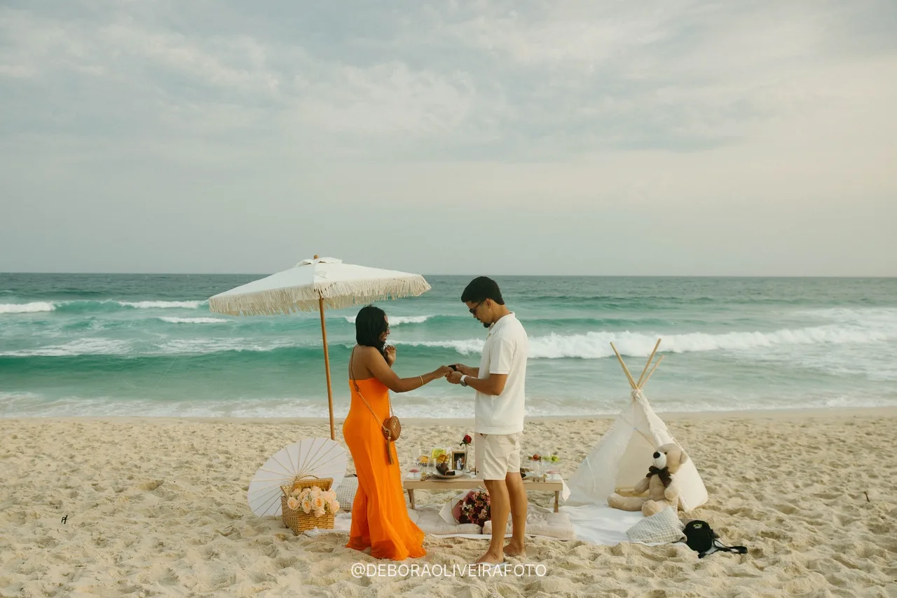 Wide view of the engaged couple and the picnic on the beach